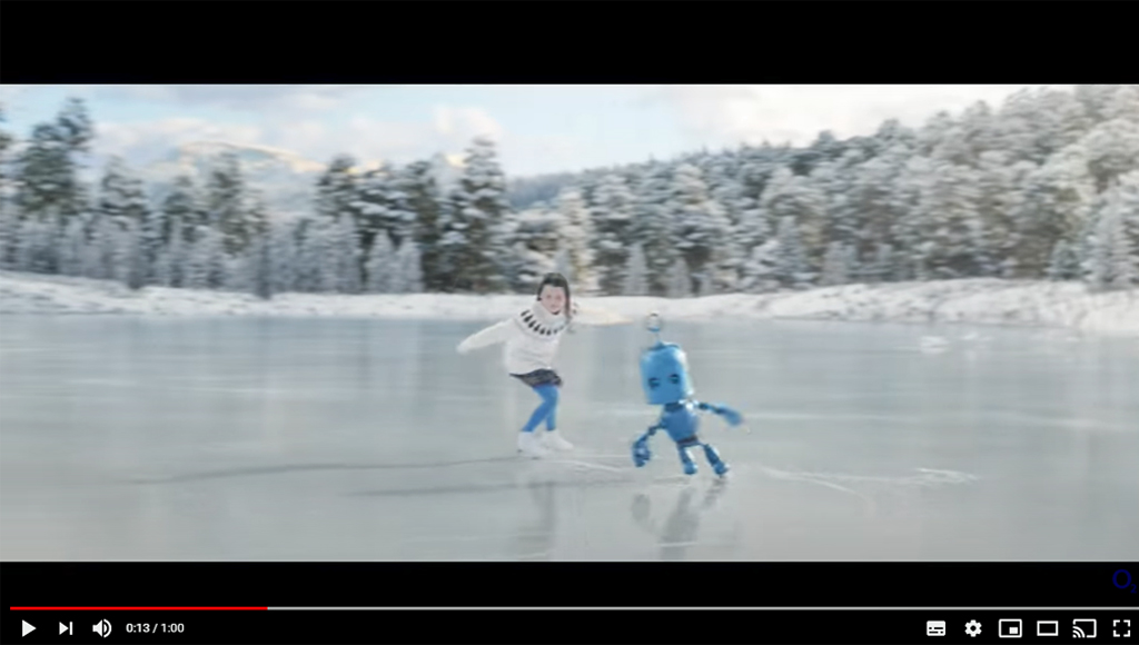 Image shows a young skater on an ice rink dancing with a blue robot
